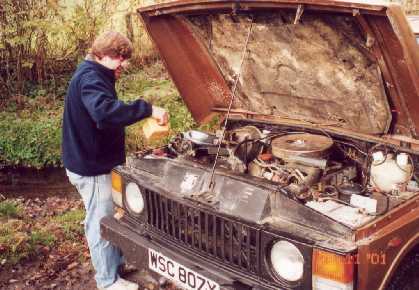 Dick filling the radiator of "the Beast" a classic Rangerover