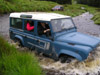 Dick at the wheel of the Landrover 110 CSW fording the river