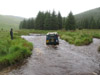 Landrover 110 CSW driving down the riverbed at Strata Florida