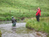 Julian checking the water depth at Strata Florida encouraged by Jamie