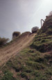 Mitsubishi Pickup Truck at the top of an off road hill at Devils Pit, venturing over the edge and about to come down it. Date: April 2005